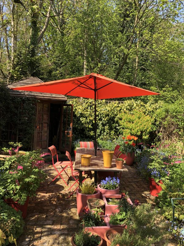 Colourful garden parasol and chairs